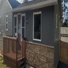 Installed Mastic Board & Batten Vertical Vinyl Siding, Thermo-Tech Full-Frame Replacement Windows, Ledgestone Versetta Accent Stone in Plover, WI 1