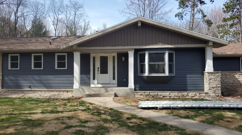 Mastic Carved Wood & Board and Batten Vinyl Siding, Soffit & Fascia, Seamless Gutters, AZEK PVC Post Cladding Trim, and Titan Clad Garage Door Installation in Steven's Point, WI