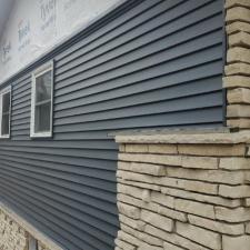 Mastic Carved Wood & Board and Batten Vinyl Siding, Soffit & Fascia, Seamless Gutters, AZEK PVC Post Cladding Trim, and Titan Clad Garage Door Installation in Steven's Point, WI 5